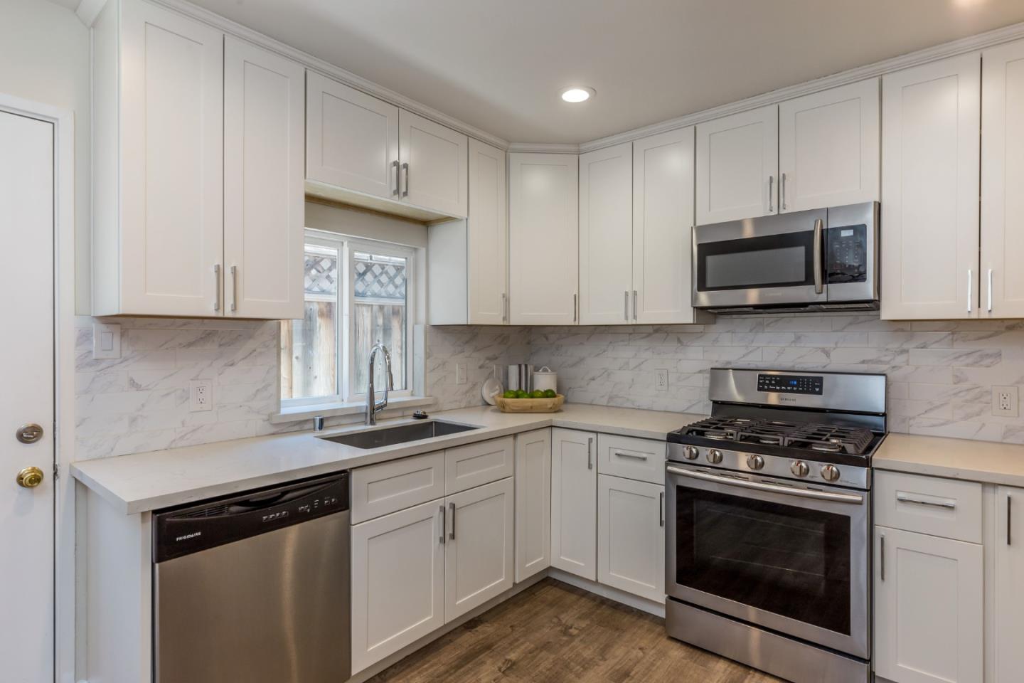 552 Marsh Road Menlo Park, CA 94025 - Photo 9 of 22 a kitchen with granite countertop white cabinets and stainless steel appliances