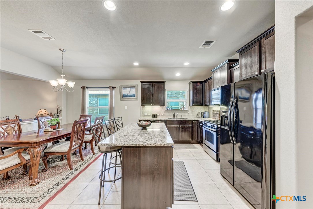 700 Cortona Cove Georgetown, TX 78628 - Photo 8 of 46 Kitchen with eat-in area, featuring propane gas range / stove