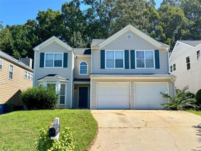 a front view of a house with garden