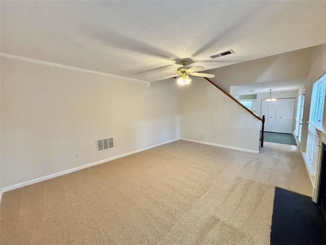 an empty room with a ceiling fan and hardwood floor