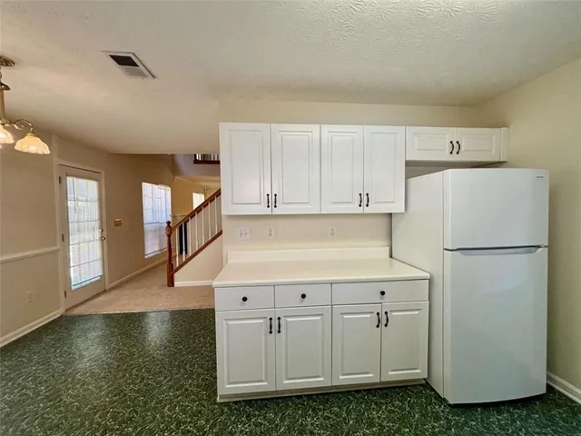 a white refrigerator freezer sitting inside of a kitchen
