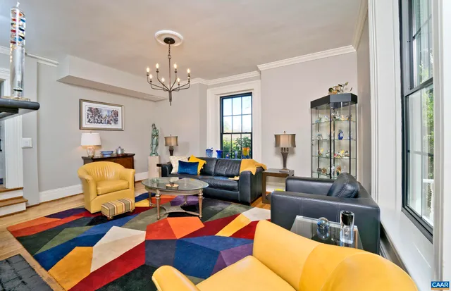 a view of a room with wooden floor and windows