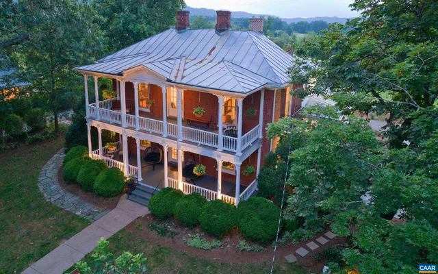 a front view of a house with yard and green space