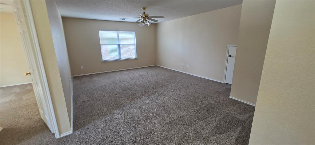 2820 Deer Ridge Drive Rockwall, TX 75032 - Photo 26 of 36 Spacious room featuring carpeting, a window with horizontal blinds, a ceiling fan, and light-toned walls