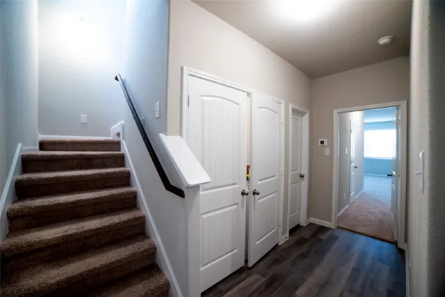 a view of entryway with wooden floor and stairs