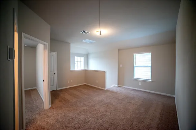 an empty room with windows and closet