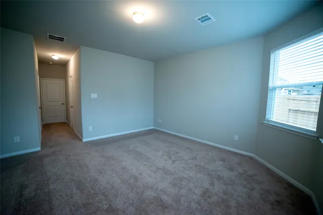 an empty room with windows and closet