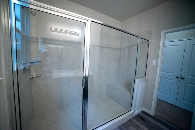a bathroom with a glass shower door