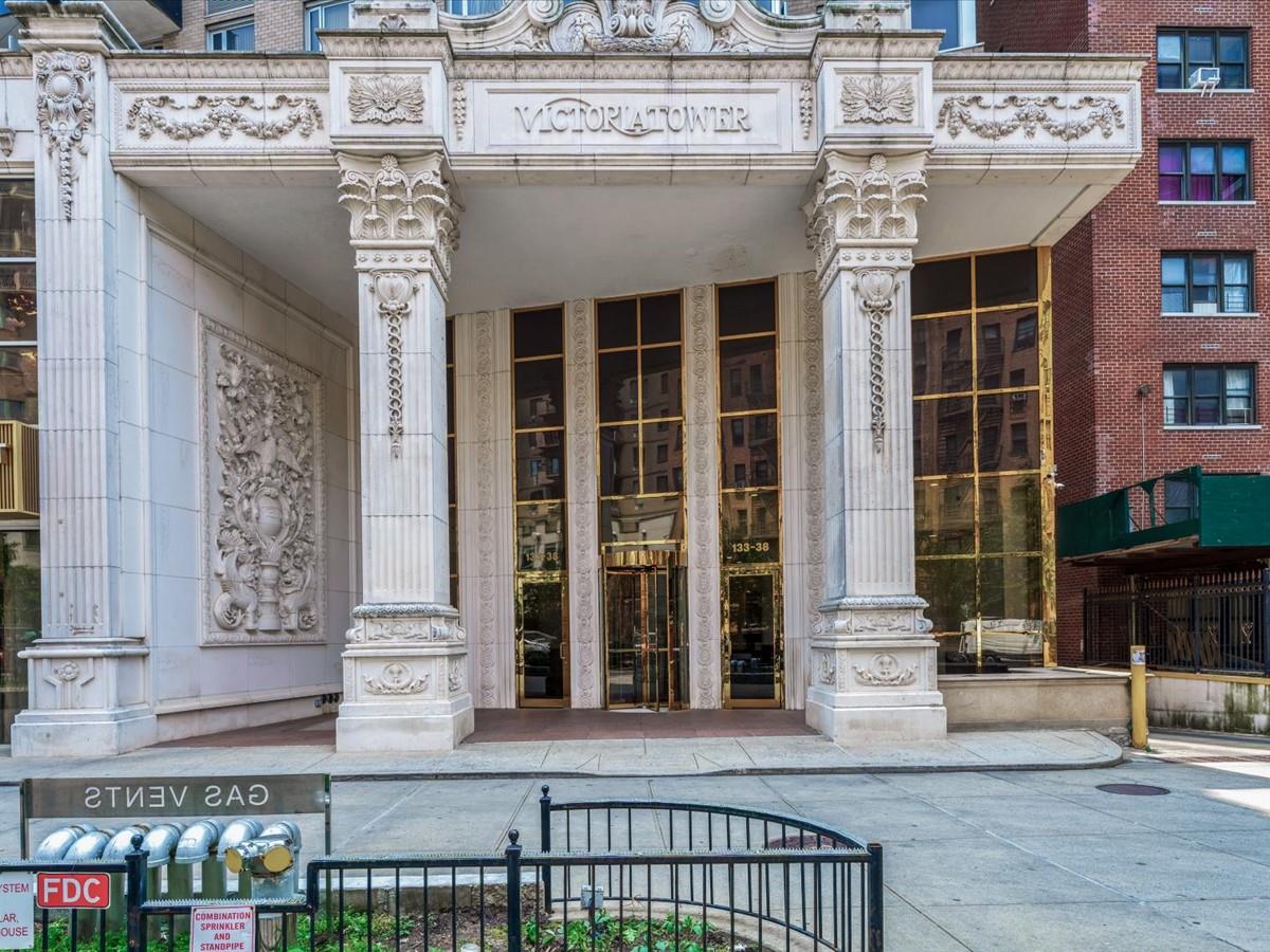 133-38 Sanford Avenue, Unit 11C Queens, NY 11355 - Photo 2 of 24 a front view of a building with glass windows and door