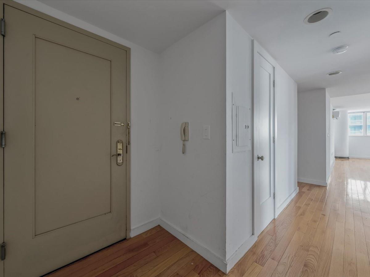 133-38 Sanford Avenue, Unit 11C Queens, NY 11355 - Photo 5 of 24 a view of a hallway with wooden floor