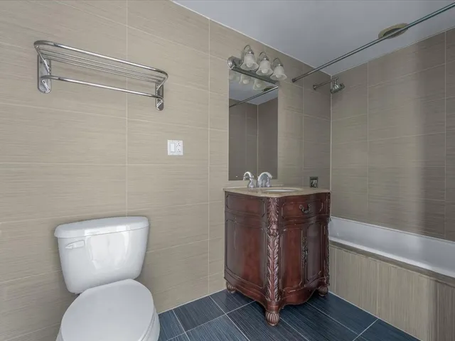 a bathroom with a toilet a sink and bathtub