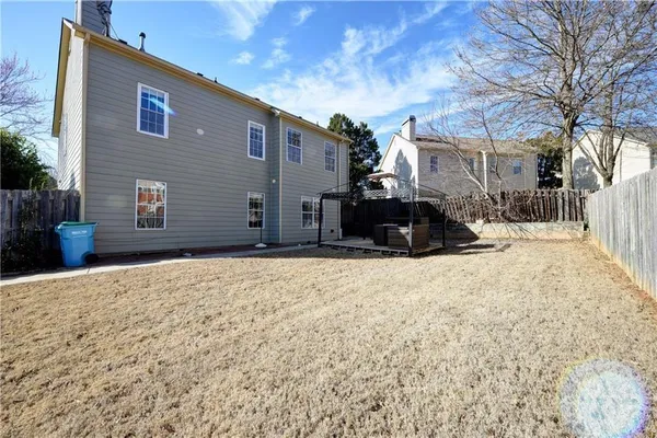 a front view of a house with a yard covered in snow