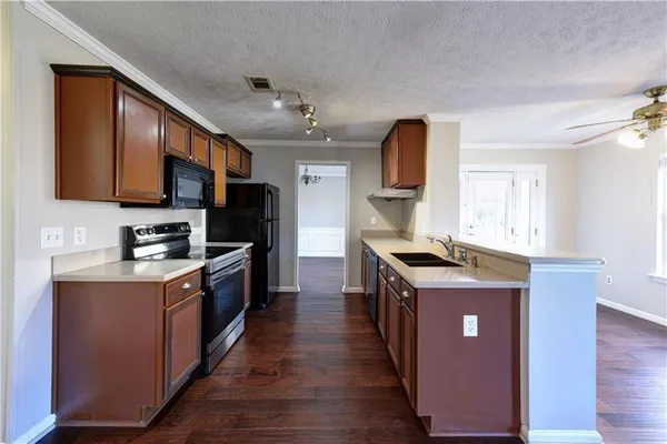 a kitchen with granite countertop a stove top oven and sink