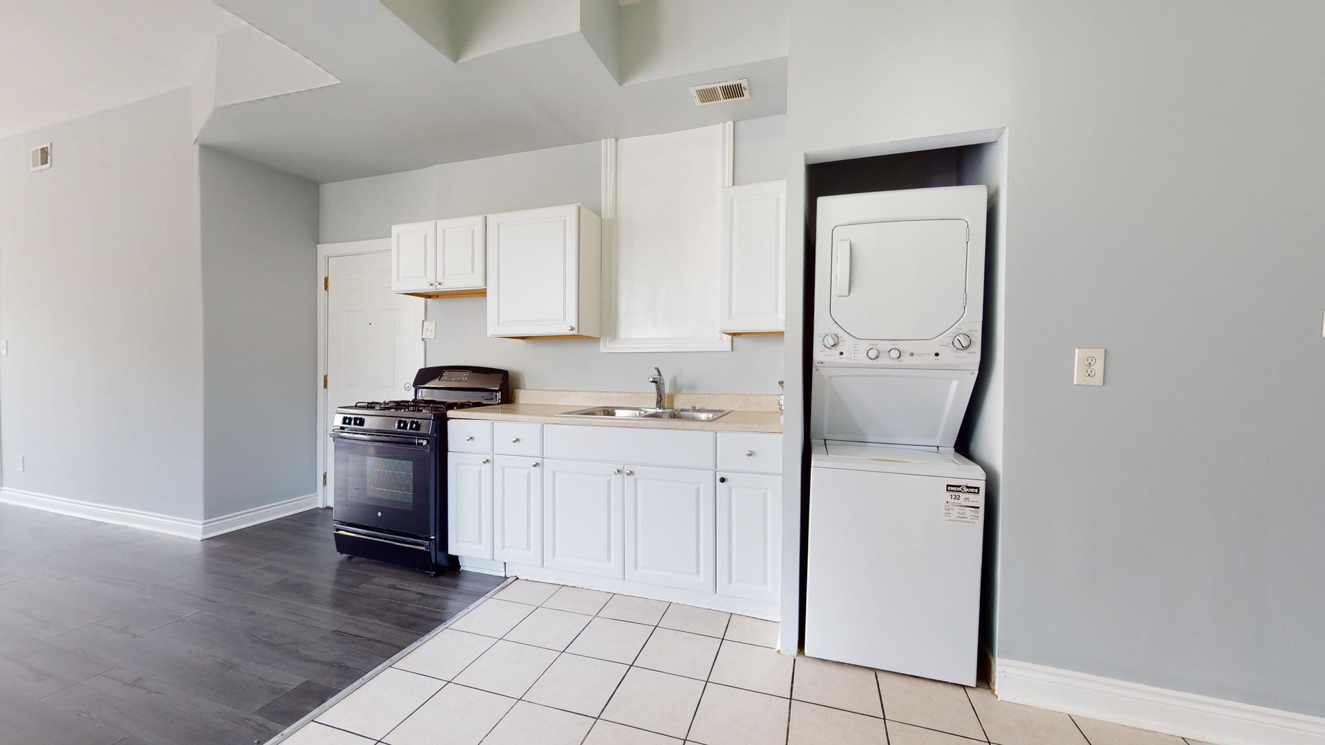 2700 West Cermak Road, Unit 2F Chicago, IL 60608 - Photo 7 of 16 a kitchen with cabinets and appliances