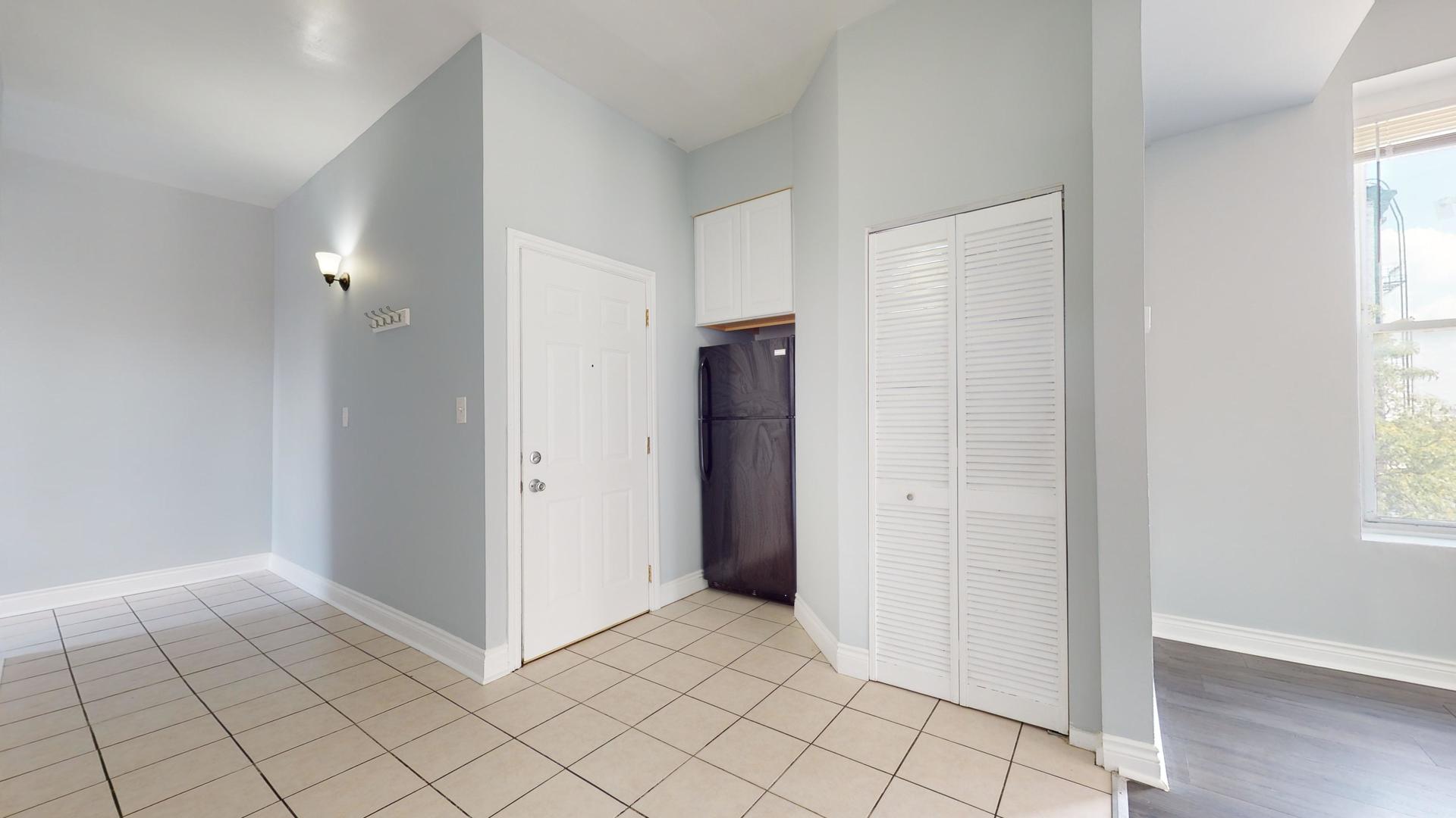 2700 West Cermak Road, Unit 2F Chicago, IL 60608 - Photo 9 of 16 a view of an empty room and window