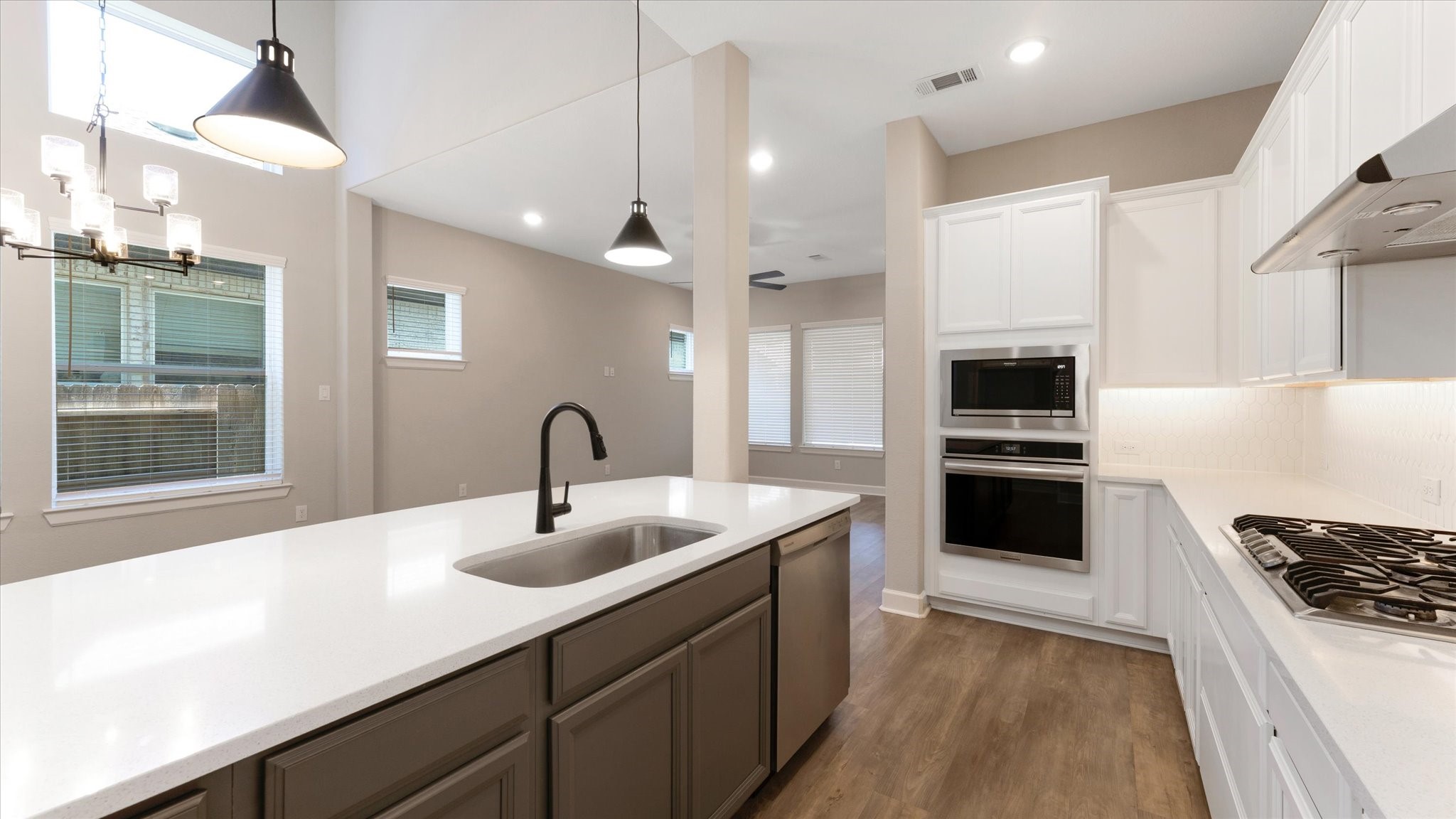 15607 Rising Wren Court Conroe, TX 77302 - Photo 11 of 40 a kitchen with kitchen island white cabinets and appliances