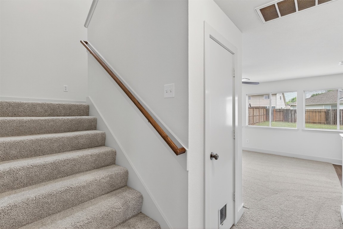 803 Dragonfly Drive Conroe, TX 77301 - Photo 12 of 50 a view of staircase with white walls and windows