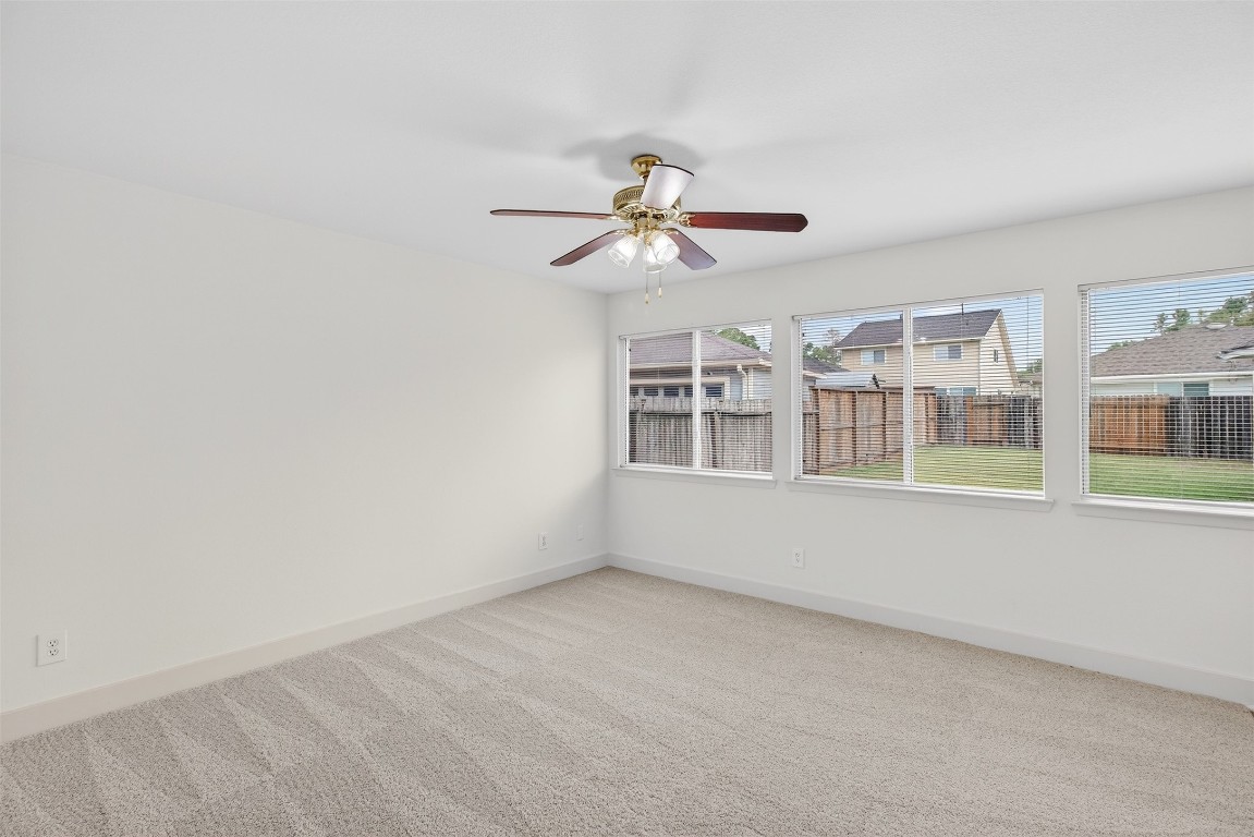 803 Dragonfly Drive Conroe, TX 77301 - Photo 13 of 50 a view of a room with a ceiling fan and window
