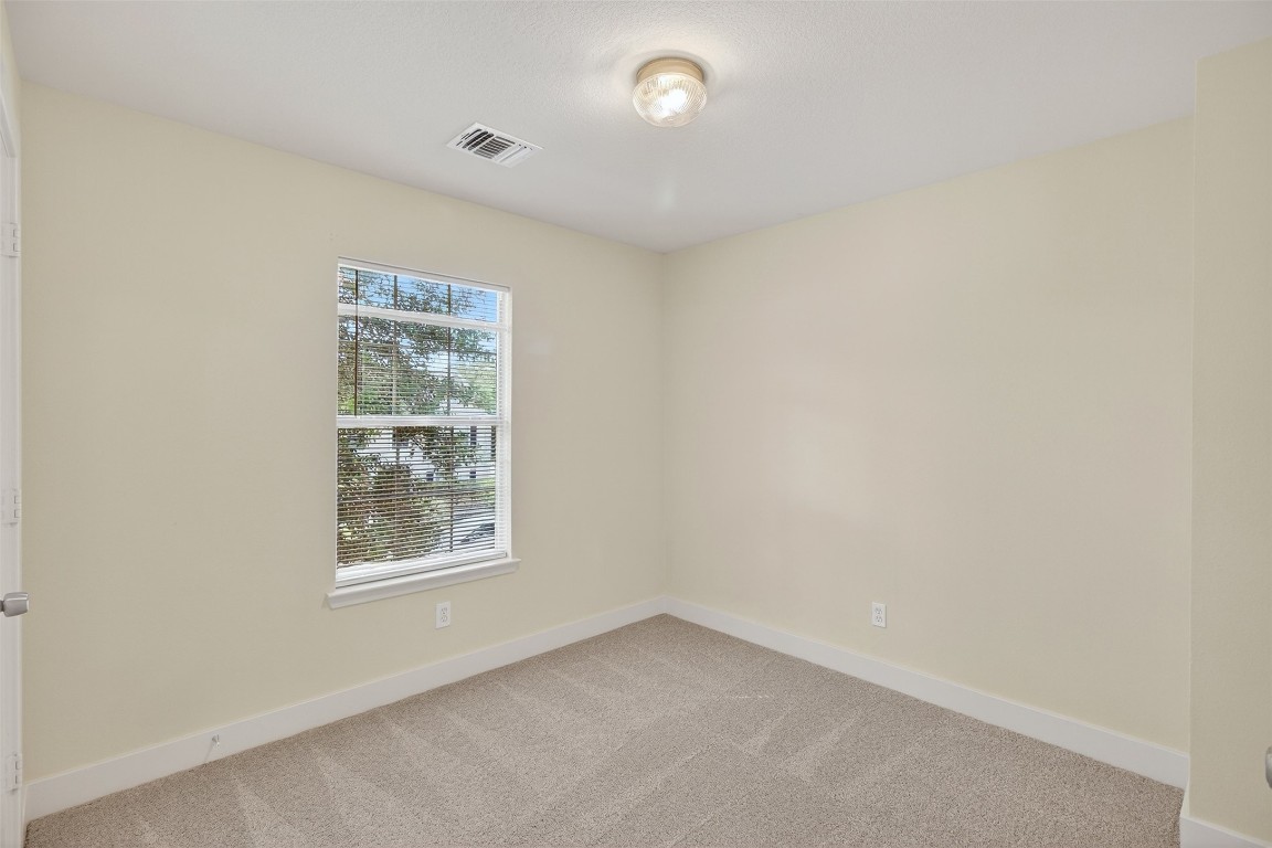 803 Dragonfly Drive Conroe, TX 77301 - Photo 33 of 50 an empty room with windows