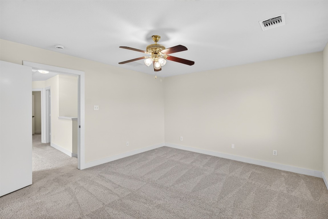803 Dragonfly Drive Conroe, TX 77301 - Photo 41 of 50 an empty room with a ceiling fan and a window