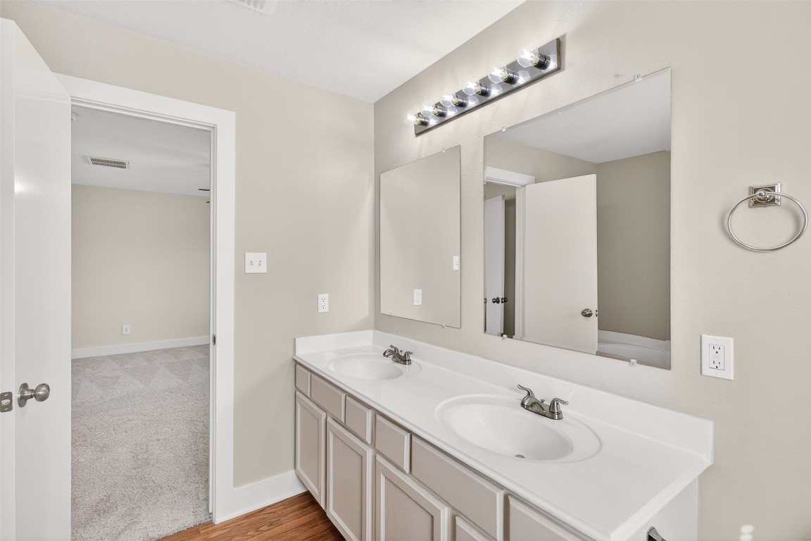 803 Dragonfly Drive Conroe, TX 77301 - Photo 46 of 50 a bathroom with a double vanity sink and a mirror