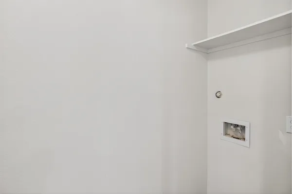 a backyard of a house with yard plants and wooden fence