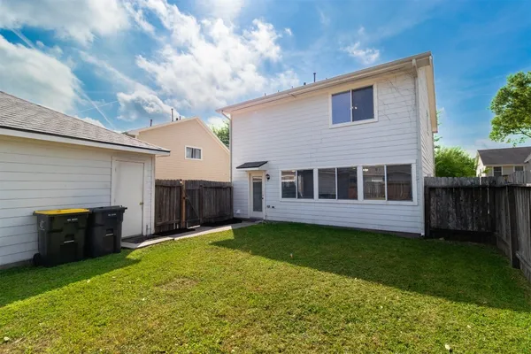 a view of a house with a yard and pathway