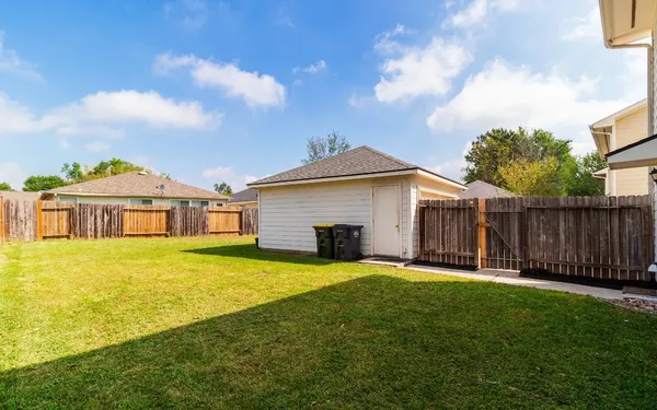 a view of a house with swimming pool and a yard
