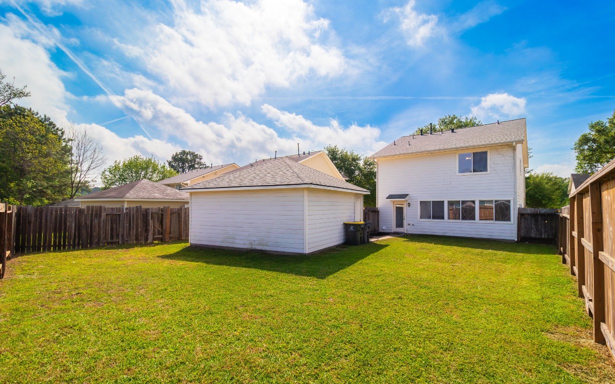 803 Dragonfly Drive Conroe, TX 77301 - Photo 50 of 50 a view of a house with swimming pool and a yard