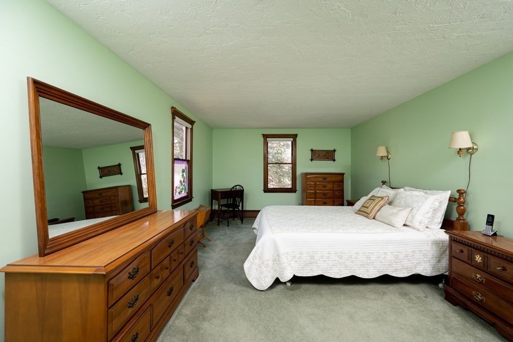 32 Old County Road Hingham, MA 02043 - Photo 20 of 38 a bedroom with a bed and large windows