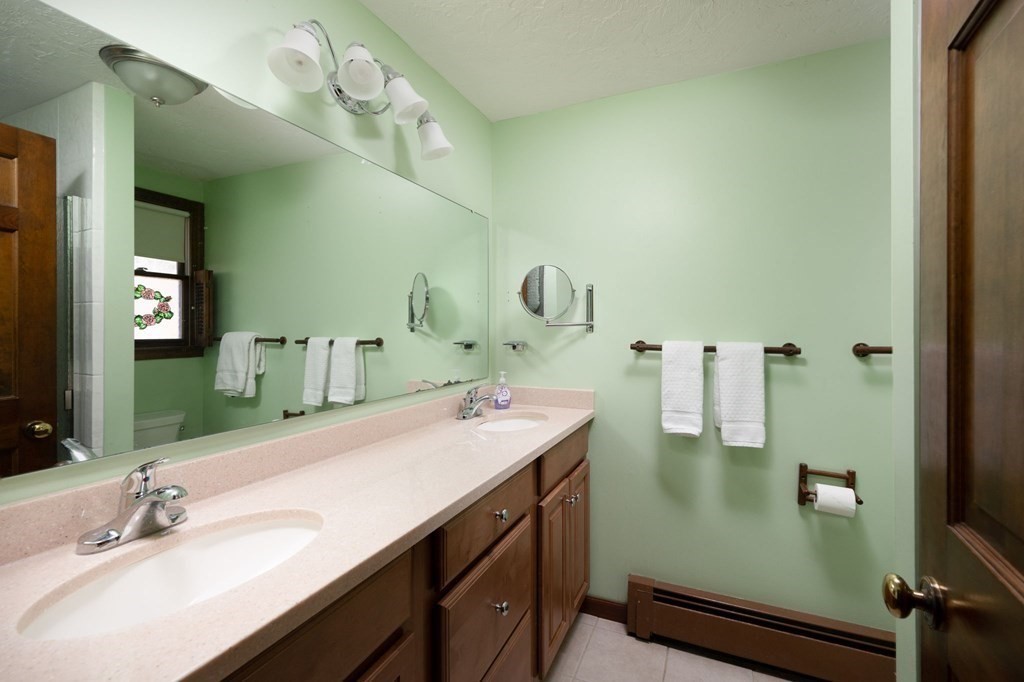32 Old County Road Hingham, MA 02043 - Photo 22 of 38 a bathroom with a sink double vanity and a mirror