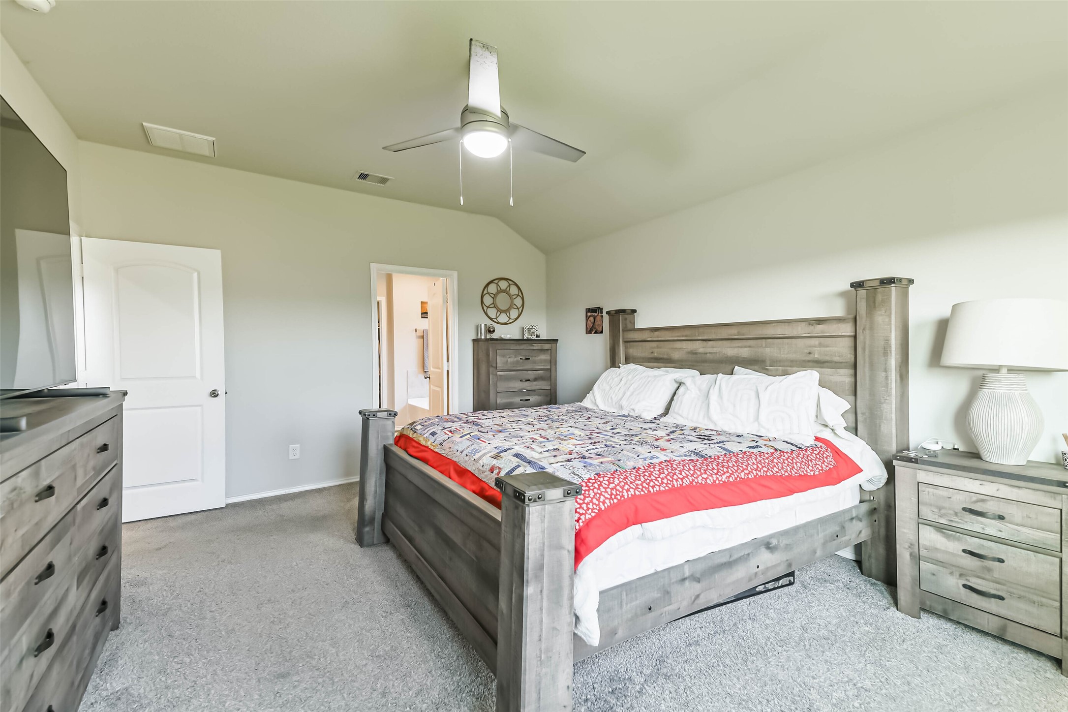 20342 Green Mountain Drive New Caney, TX 77357 - Photo 14 of 30 a bedroom with a bed and a lamp on dresser