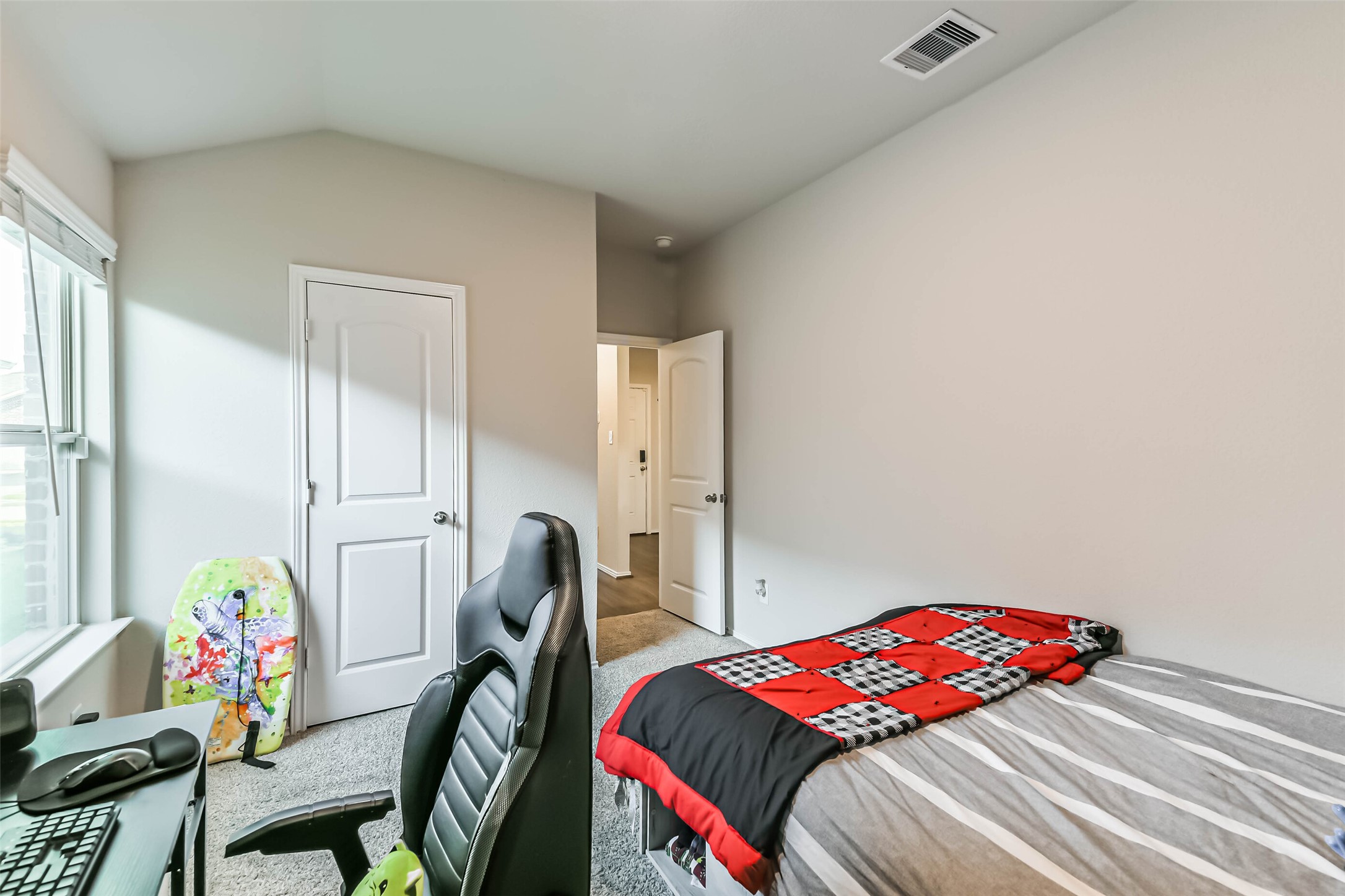 20342 Green Mountain Drive New Caney, TX 77357 - Photo 23 of 30 a bedroom with a bed a desk and chair