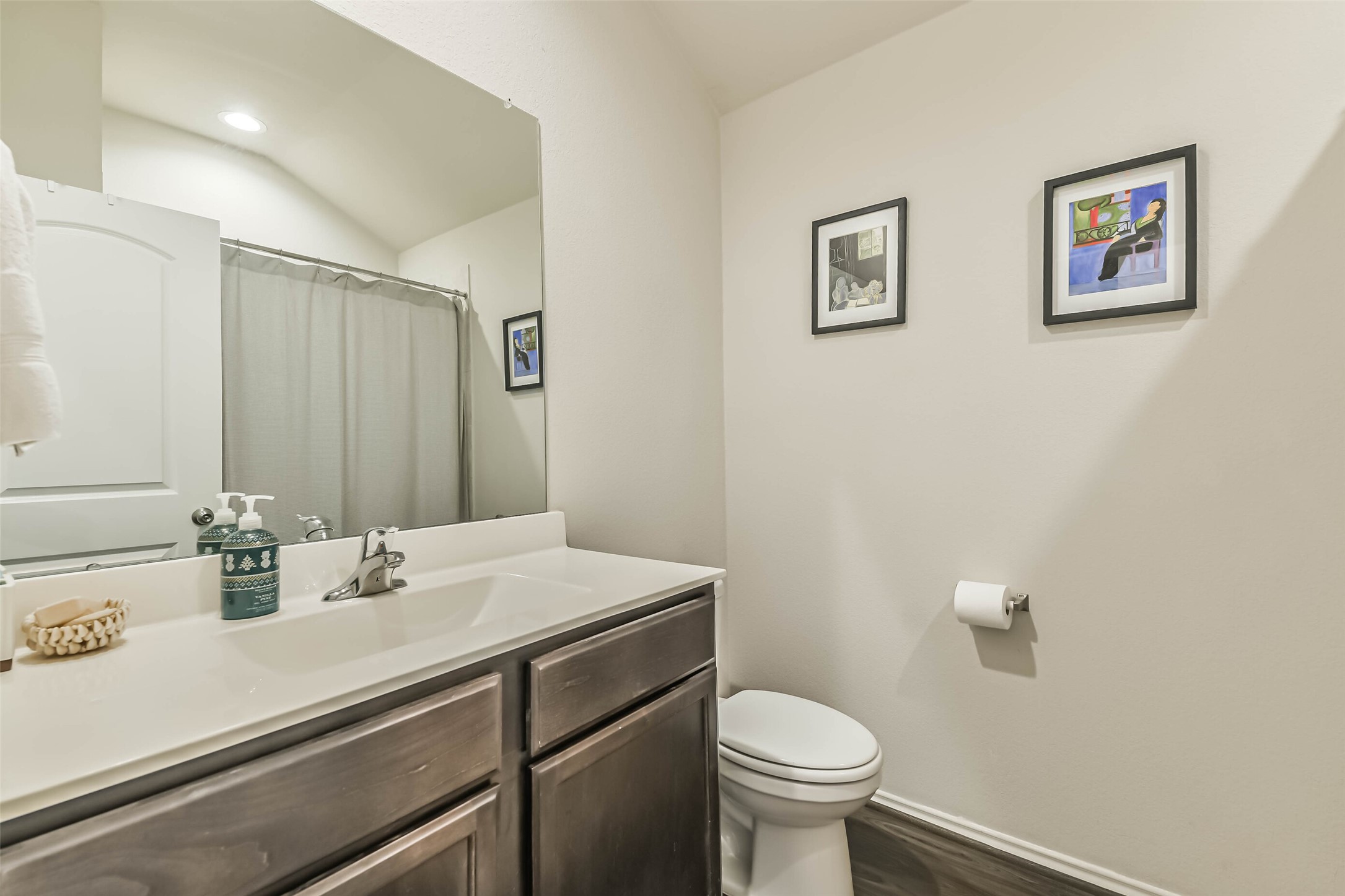 20342 Green Mountain Drive New Caney, TX 77357 - Photo 24 of 30 a bathroom with a sink a toilet and mirror
