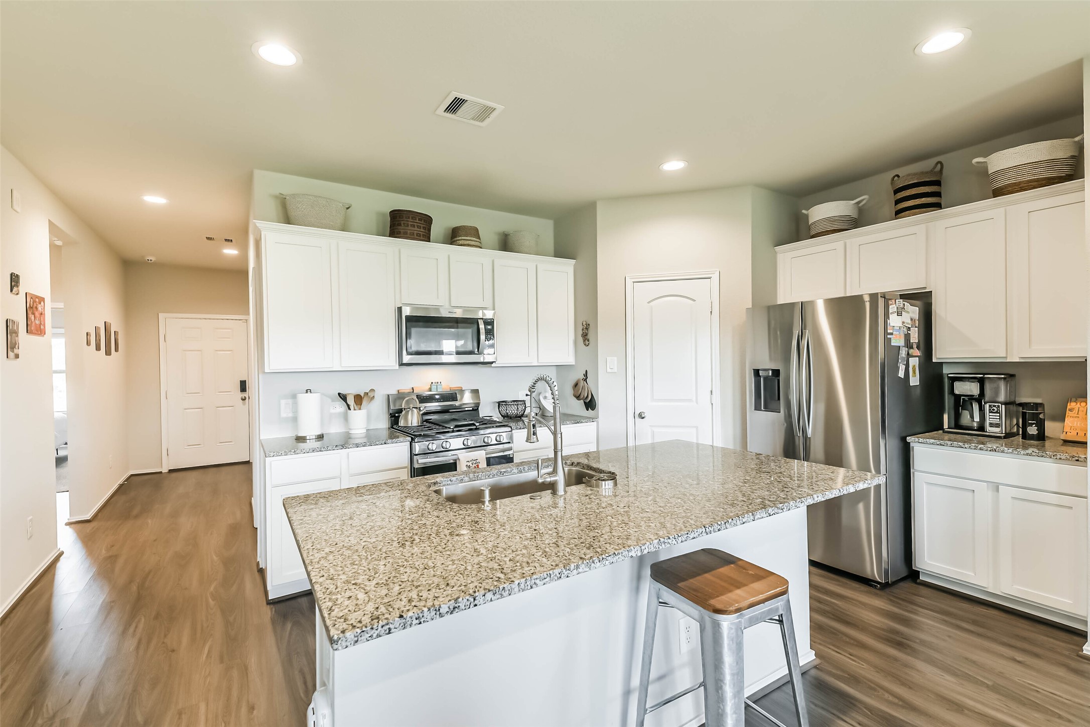 20342 Green Mountain Drive New Caney, TX 77357 - Photo 5 of 30 a kitchen with stainless steel appliances granite countertop a sink a stove a refrigerator cabinets and chairs