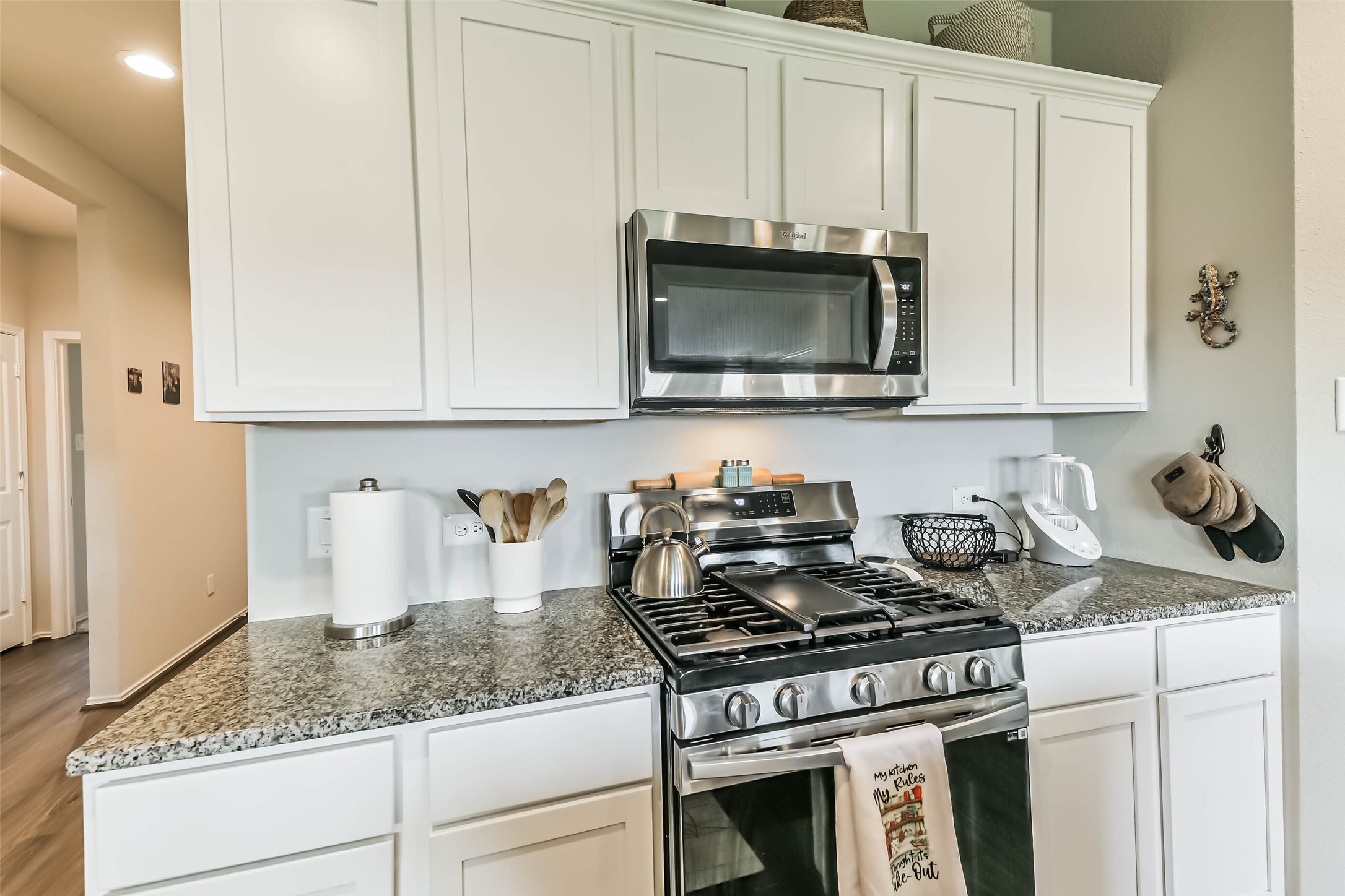 20342 Green Mountain Drive New Caney, TX 77357 - Photo 6 of 30 a kitchen with granite countertop stainless steel appliances a stove a microwave and cabinets