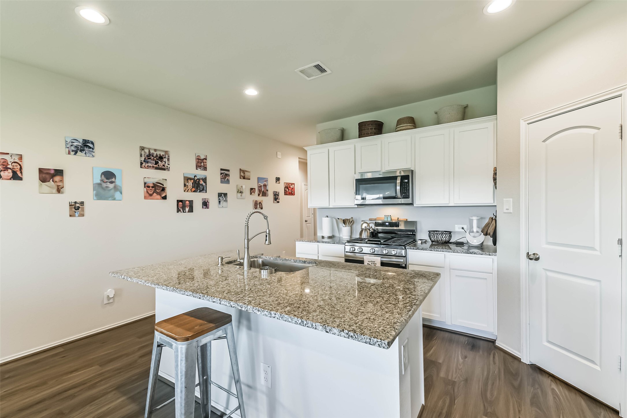 20342 Green Mountain Drive New Caney, TX 77357 - Photo 9 of 30 a kitchen with granite countertop cabinets stainless steel appliances and a wooden floor