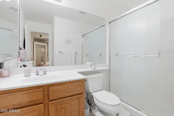 a bathroom with a sink a toilet a mirror and vanity