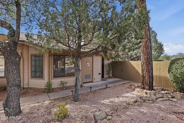 a view of a house with a tree in the background
