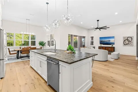 a kitchen with stainless steel appliances granite countertop a stove and kitchen island
