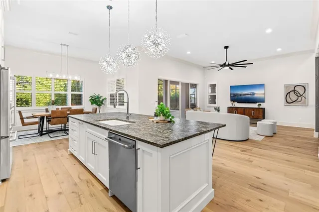 a kitchen with stainless steel appliances granite countertop a stove and kitchen island