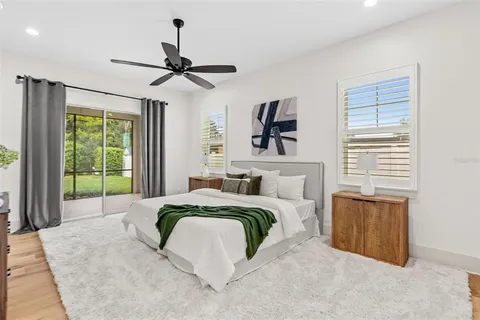 a spacious bedroom with a bed a window and a chandelier
