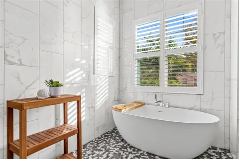 a bath tub sitting next to a window