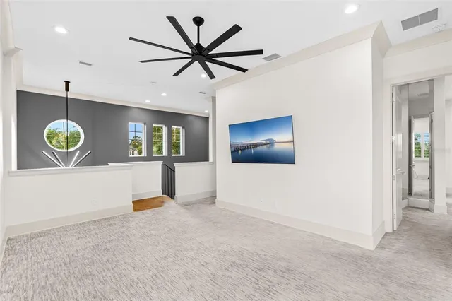 wooden floor in a hall with a window and a chandelier