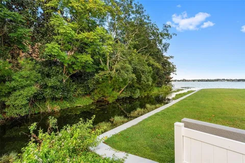 a view of a green yard with a lake view