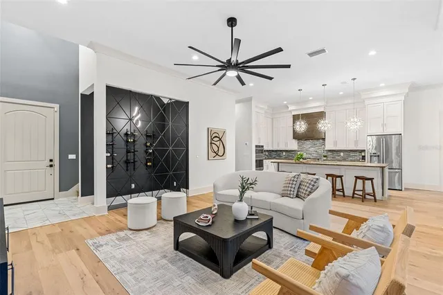 a living room with furniture and kitchen view