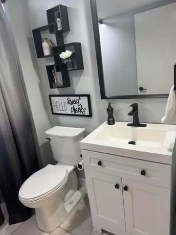 a bathroom with a sink a toilet and mirror