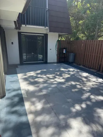 a view of a house with backyard and wooden fence