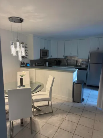 a kitchen with stainless steel appliances a stove a sink a microwave and a refrigerator