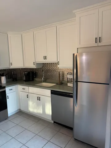 a white refrigerator freezer sitting in a kitchen